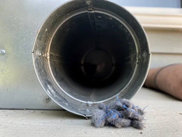 Orlando Dryer Vent Cleaning technician using specialized equipment to clear severe dryer vent blockage in Orlando